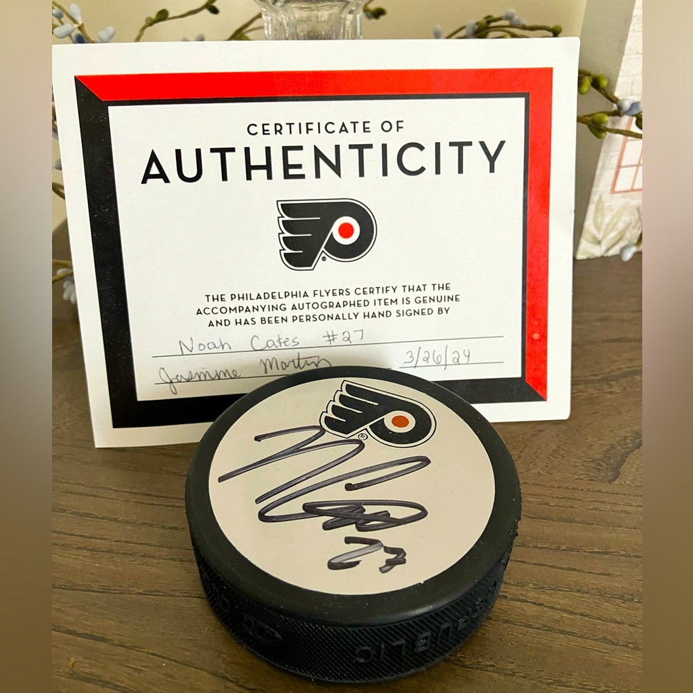 Noah Cates #27 autographed hockey puck and Certificate of Authenticity